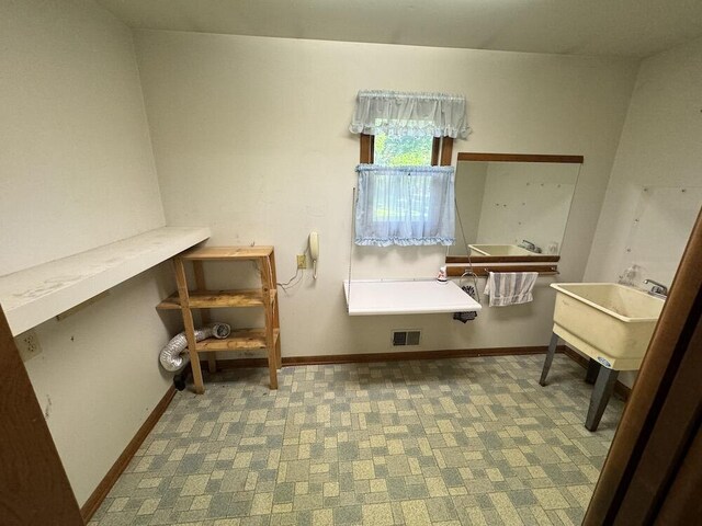 5490 S Harrison Rd, Houghton Lake, MI 48629 - bathroom featuring a sink and baseboards