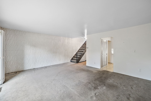 unfurnished living room featuring light carpet