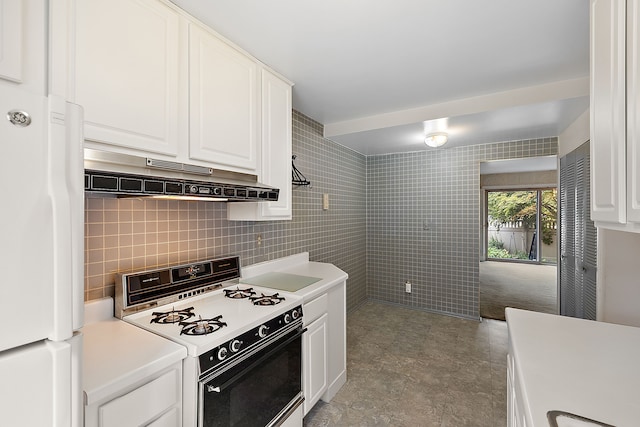 kitchen featuring backsplash, white cabinetry, white appliances, and tile walls