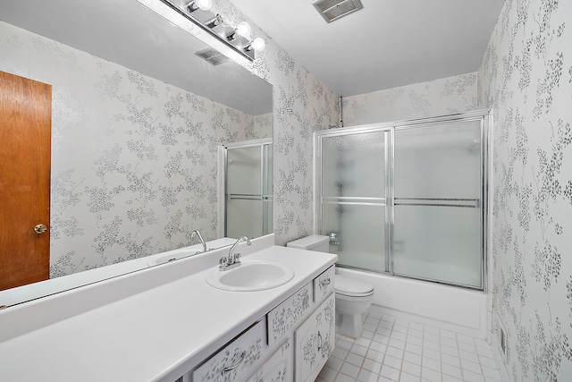 full bathroom featuring tile patterned floors, shower / bath combination with glass door, vanity, and toilet