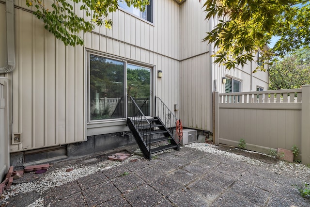 view of exterior entry with a patio