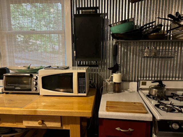 kitchen featuring white range with gas stovetop