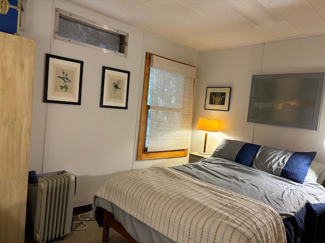 carpeted bedroom with radiator