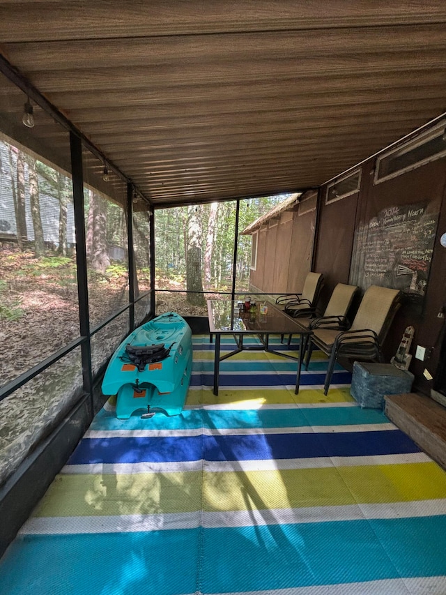 unfurnished sunroom featuring wooden ceiling and a healthy amount of sunlight