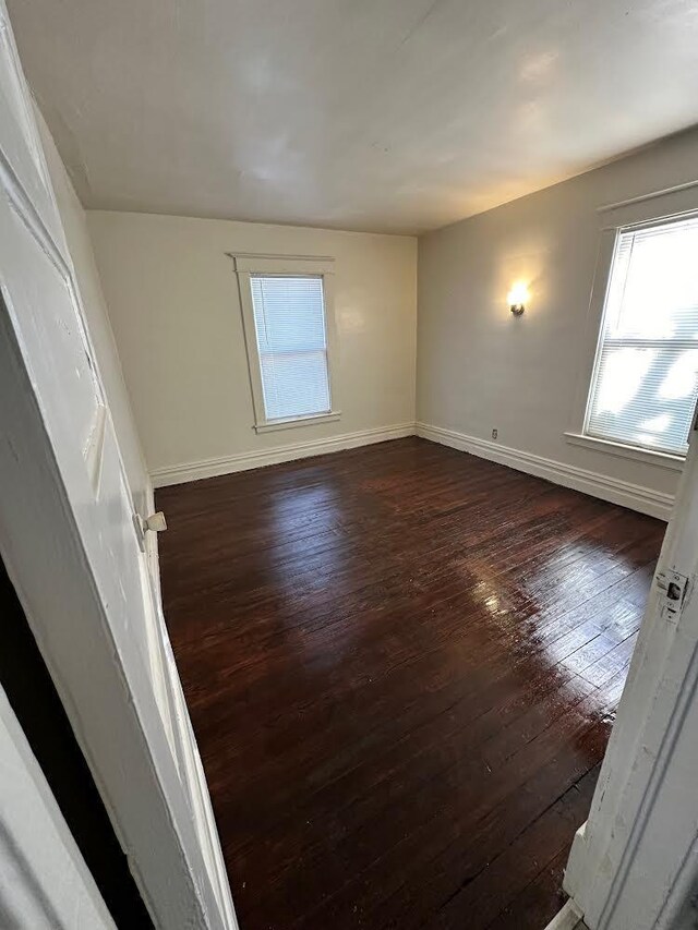 1408 E Main St, Kalamazoo, MI 49048 - unfurnished room with baseboards, plenty of natural light, and dark wood-type flooring