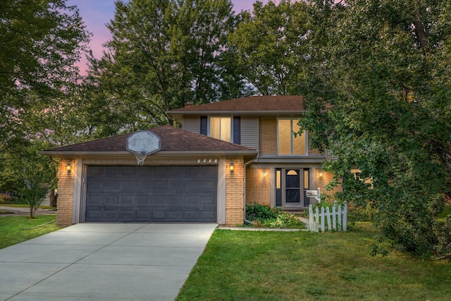 view of front of home with a garage and a lawn