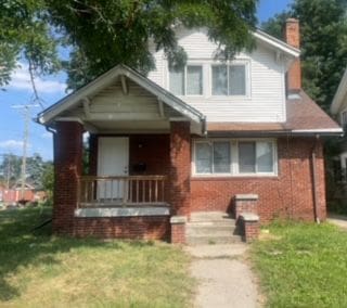 view of front of property with covered porch and a front yard