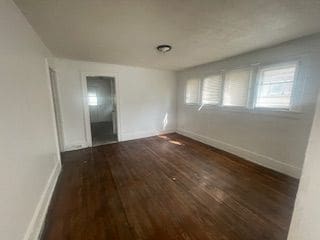 empty room featuring dark hardwood / wood-style flooring