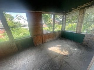 unfurnished sunroom with plenty of natural light