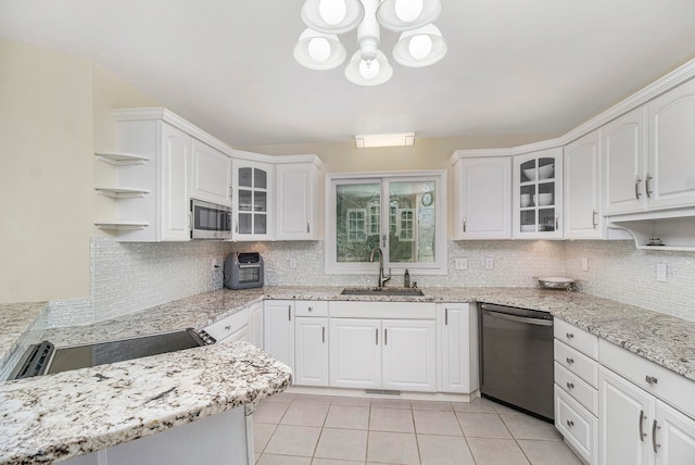 kitchen featuring backsplash, white cabinetry, sink, and appliances with stainless steel finishes