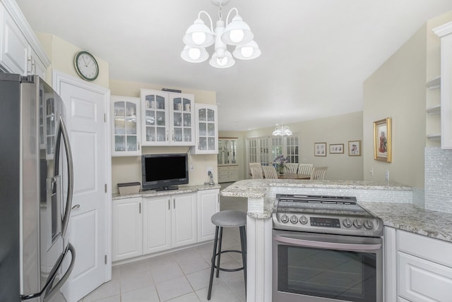 29100 Heritage Ln, Paw Paw, MI 49079 - kitchen featuring stainless steel appliances, a chandelier, white cabinets, and light tile patterned floors
