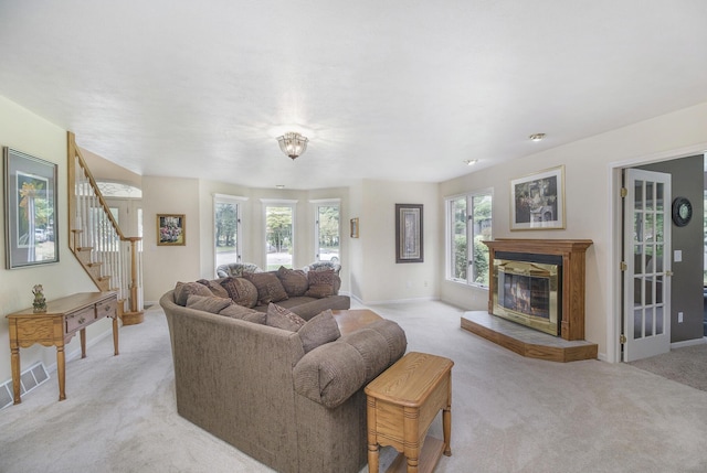 29100 Heritage Ln, Paw Paw, MI 49079 - living area with light colored carpet, a glass covered fireplace, and stairway