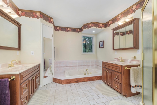 bathroom with tiled tub, tile patterned flooring, and vanity