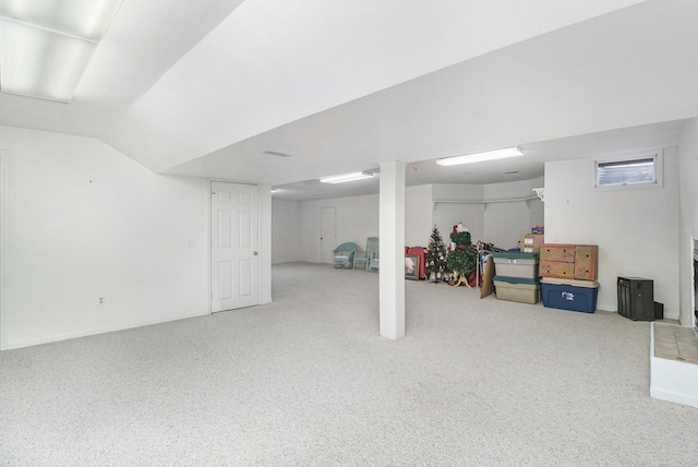 basement featuring light colored carpet