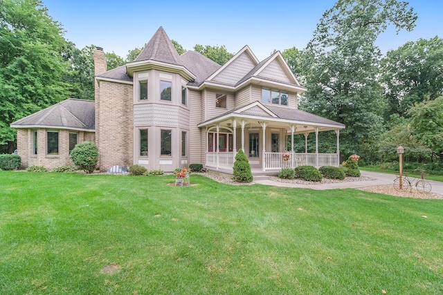 29100 Heritage Ln, Paw Paw, MI 49079 - victorian-style house with covered porch, a chimney, a front lawn, and roof with shingles