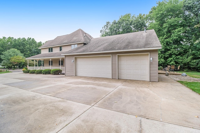 view of front of property with covered porch and a garage