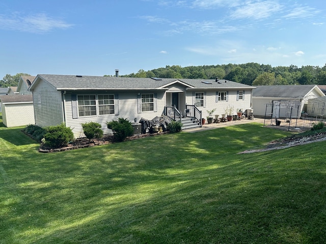 rear view of house featuring a yard