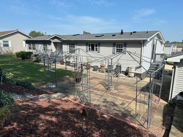 back of house featuring a yard and a patio