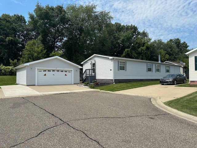 manufactured / mobile home featuring a garage and an outdoor structure