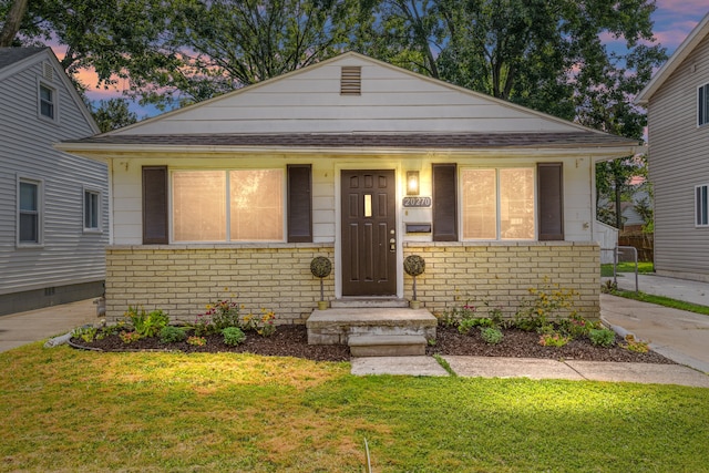 bungalow-style home featuring a lawn