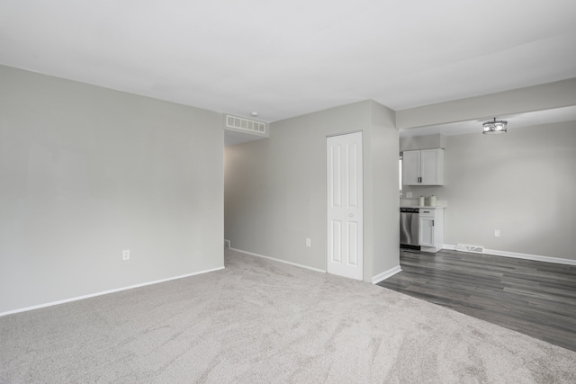 unfurnished living room with dark wood-type flooring