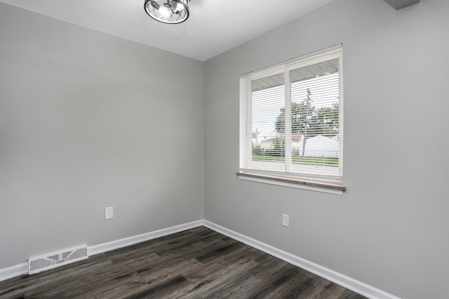 empty room with dark wood-type flooring