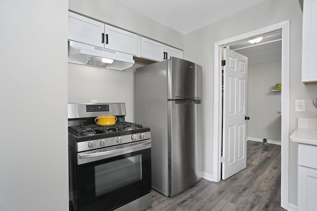 kitchen with white cabinets, stainless steel appliances, and dark wood-type flooring