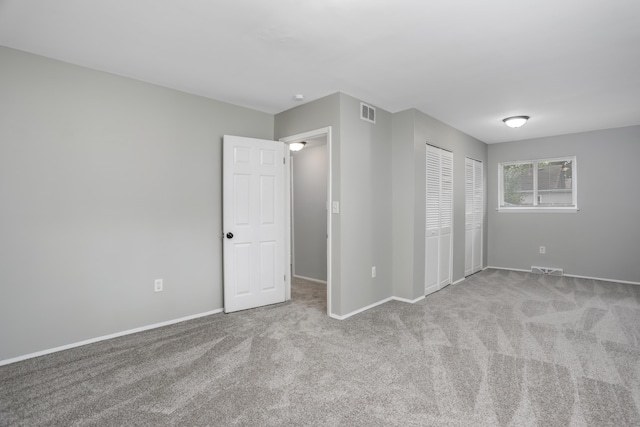 unfurnished bedroom with light colored carpet