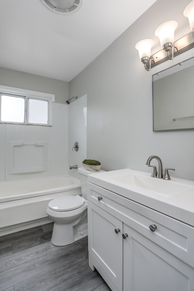 full bathroom featuring wood-type flooring, vanity, toilet, and shower / washtub combination