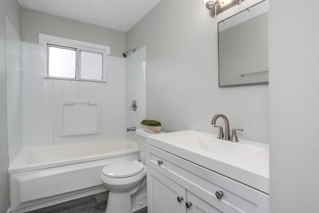 full bathroom featuring vanity, hardwood / wood-style flooring, toilet, and shower / bathtub combination