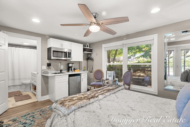 kitchen featuring plenty of natural light, white cabinets, stainless steel appliances, and sink