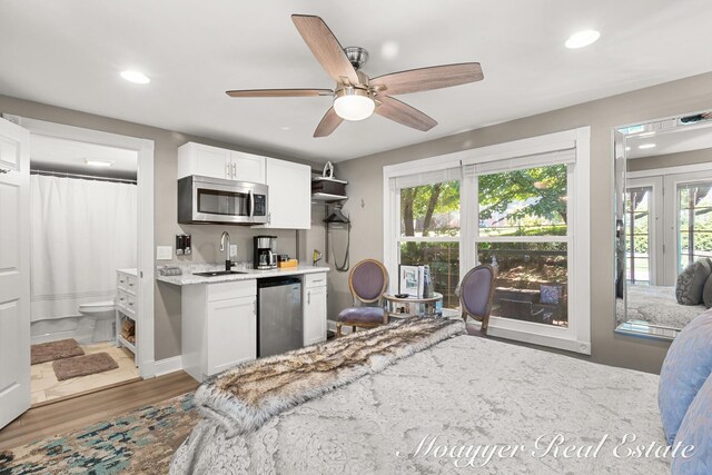 15 E Wall St, Douglas, MI 49406 - bedroom featuring recessed lighting, wood finished floors, wet bar, connected bathroom, and ceiling fan
