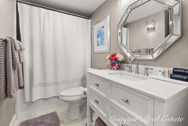 15 E Wall St, Douglas, MI 49406 - full bathroom featuring marble finish flooring, vanity, toilet, and shower / tub combo