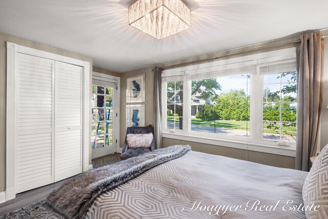 15 E Wall St, Douglas, MI 49406 - bedroom featuring wood finished floors and a chandelier