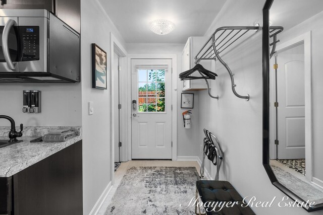 15 E Wall St, Douglas, MI 49406 - doorway featuring baseboards and a sink
