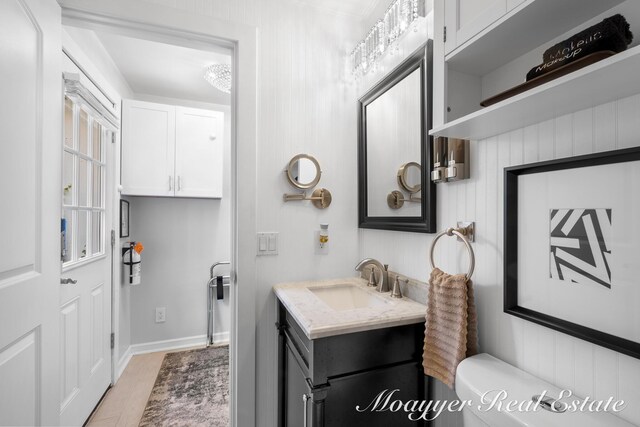 15 E Wall St, Douglas, MI 49406 - bathroom with vanity, toilet, and wood finished floors