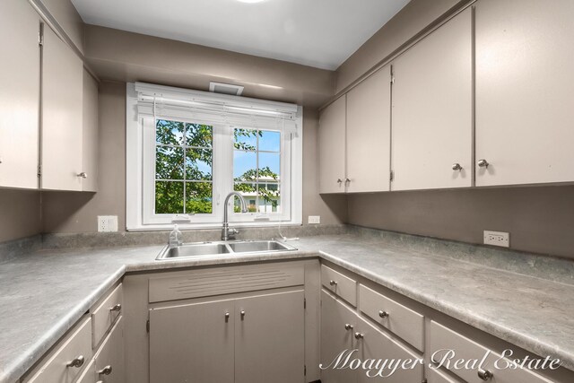 15 E Wall St, Douglas, MI 49406 - kitchen with a sink, light countertops, and gray cabinets
