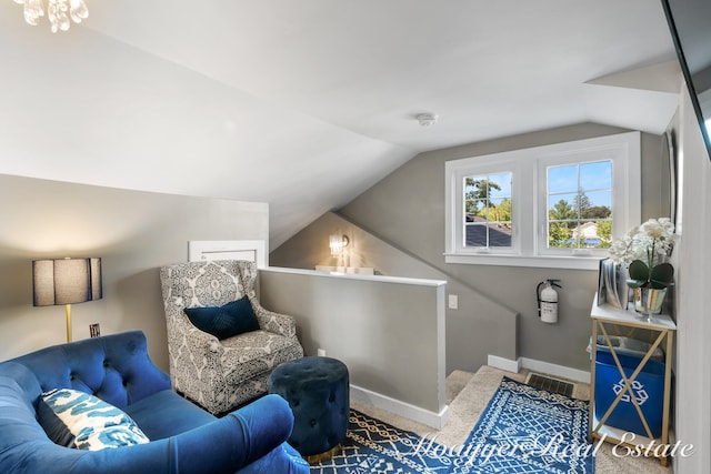 sitting room with carpet floors and lofted ceiling