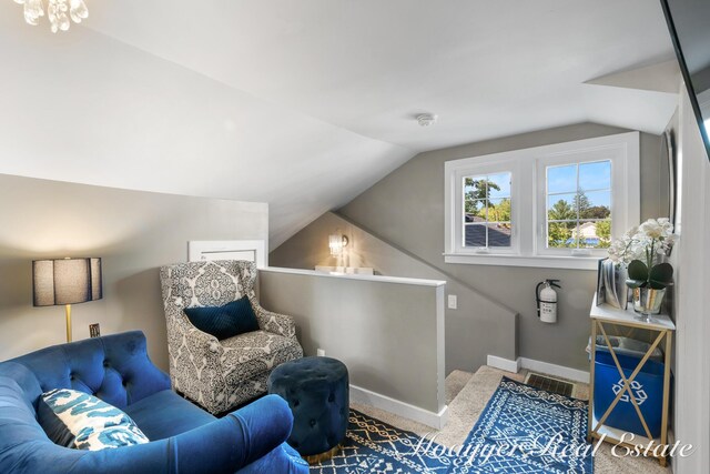 15 E Wall St, Douglas, MI 49406 - sitting room featuring carpet flooring, lofted ceiling, baseboards, and an upstairs landing