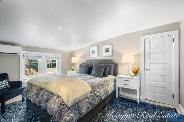 15 E Wall St, Douglas, MI 49406 - bedroom with a wall unit AC, lofted ceiling, baseboards, and dark carpet