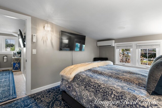 15 E Wall St, Douglas, MI 49406 - bedroom with a wall mounted air conditioner, carpet, baseboards, and vaulted ceiling
