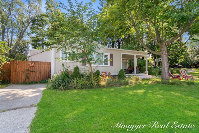 view of front of home featuring covered porch and a front yard