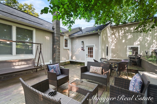 wooden deck with an outdoor living space