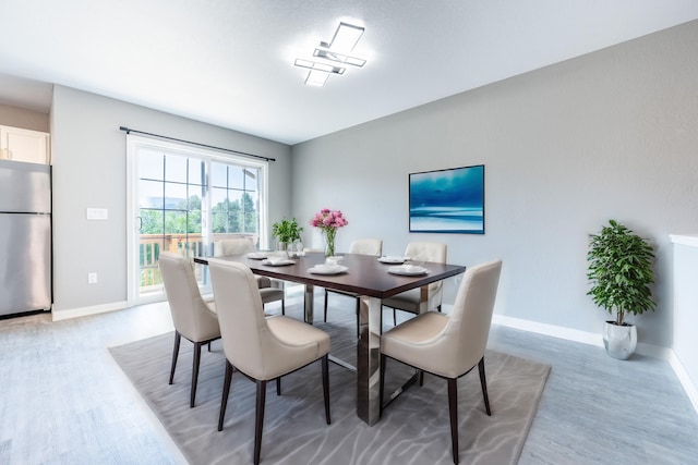 dining space featuring wood-type flooring