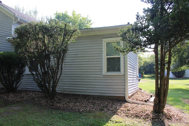 view of home's exterior with a lawn