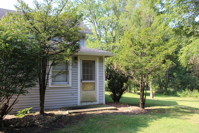 entrance to property with a lawn