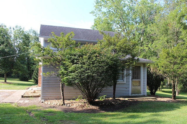 view of property exterior with a lawn