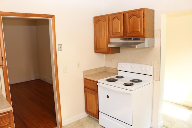 kitchen with light hardwood / wood-style floors and white electric range