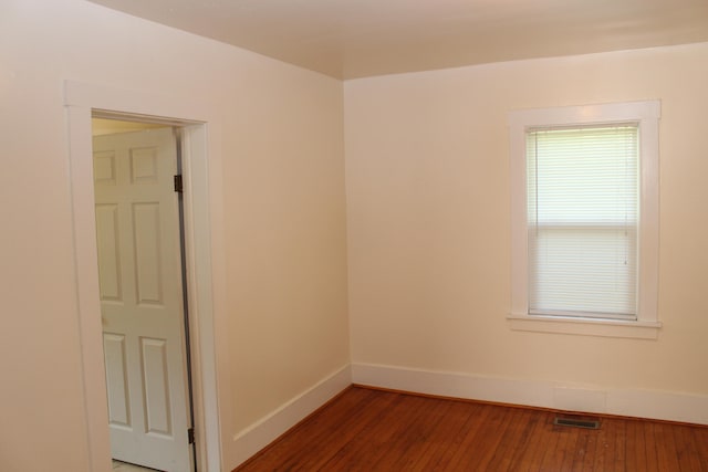 unfurnished room with dark wood-type flooring