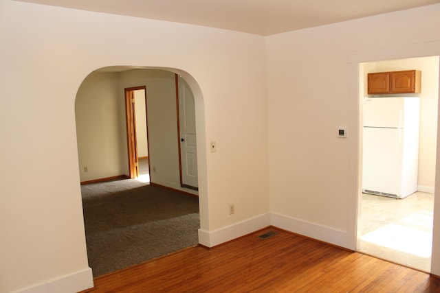 spare room featuring hardwood / wood-style flooring